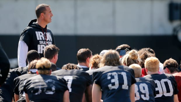 Luke Fickell speaking with his Cincinnati team during fall camp.
